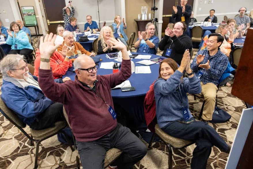 Delegates cheer and applaud after a vote